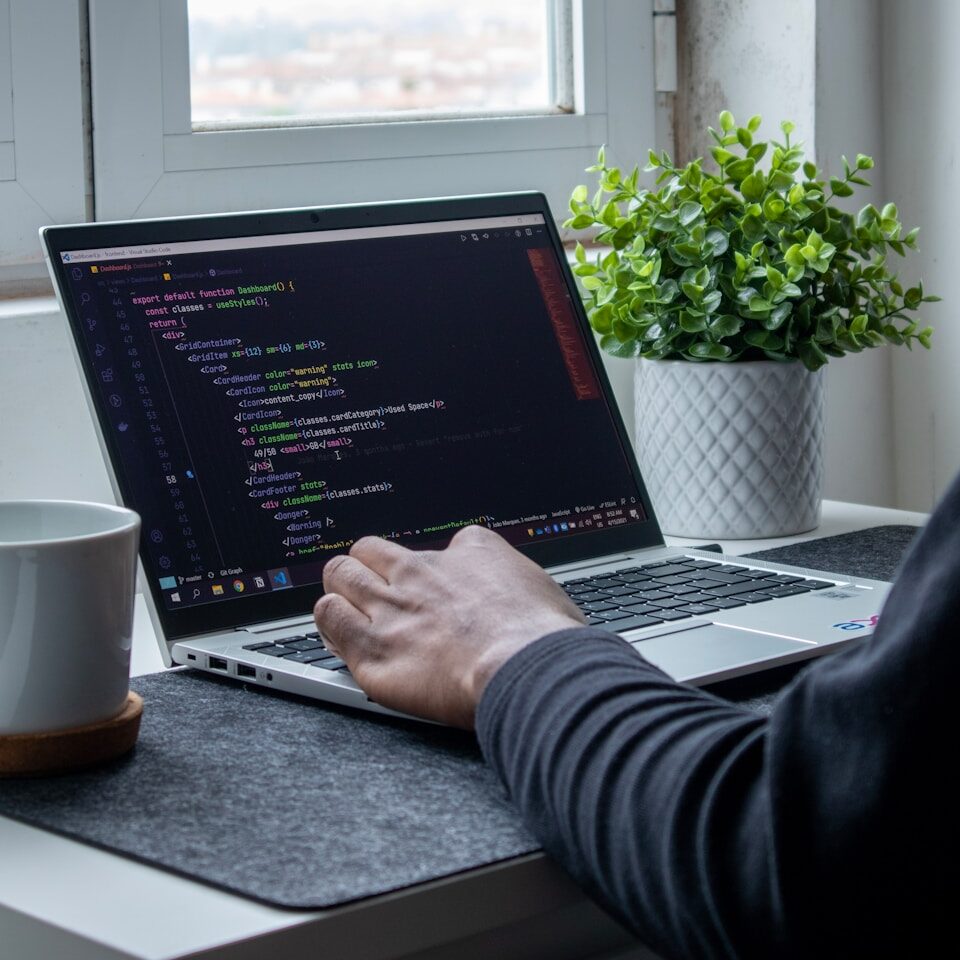 person using macbook pro on table